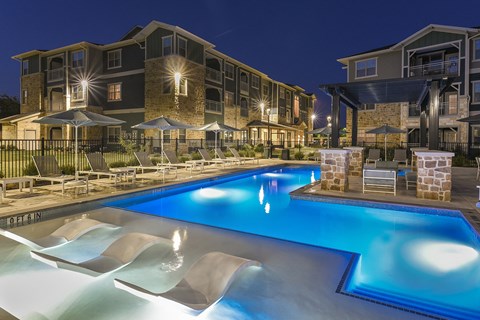 Resort-style swimming pool with comfortable lounge seating and a beautifully maintained outdoor space designed for relaxation.