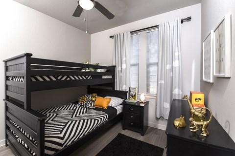 Bright secondary bedroom with comfortable furnishings, ample space, and a welcoming design suited for guests, family members, or a home office.