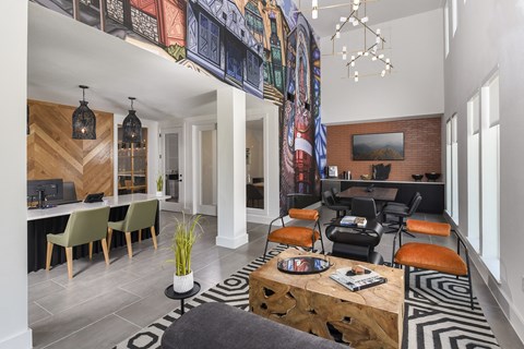 A living room with a black couch and a coffee table.