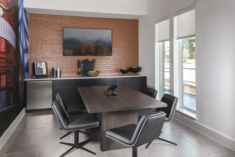 Modern business center featuring computer workstations, comfortable seating, and a productive workspace for remote work or study.