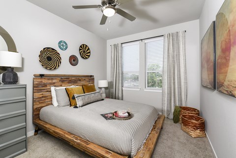 Spacious primary bedroom featuring comfortable furnishings, abundant natural light, and a relaxing atmosphere designed for everyday comfort.