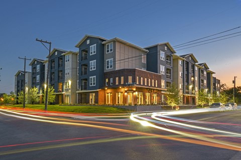Modern apartment community featuring contemporary architecture, beautifully maintained landscaping, and inviting curb appeal.