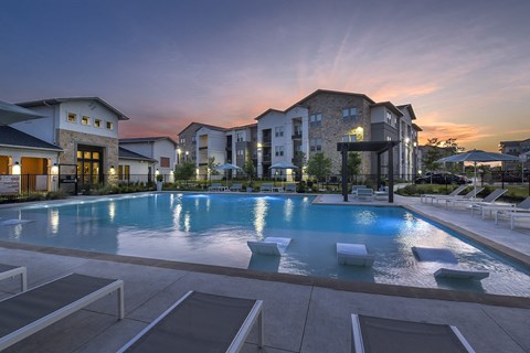 Resort-style swimming pool with comfortable lounge seating and a beautifully maintained outdoor space designed for relaxation.