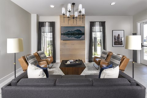 A living room with a grey couch and a wooden coffee table.
