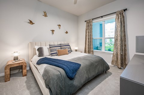 a bedroom with a large bed and a large window
