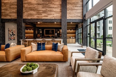 A living room with a bowl of green fruit on the coffee table.