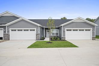 a house with a gray siding and a gray garage door