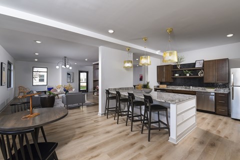 A modern kitchen with a dining table and chairs.