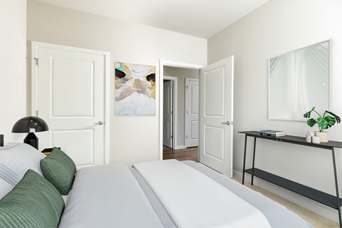 Spacious primary bedroom featuring comfortable furnishings, abundant natural light, and a relaxing atmosphere designed for everyday comfort.
