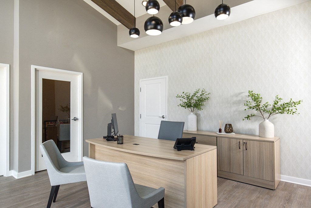 a modern office with a desk and chairs