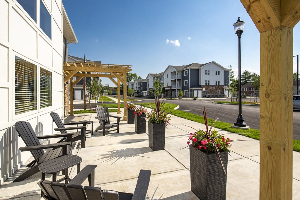 an outdoor patio with tables and chairs outside of a building