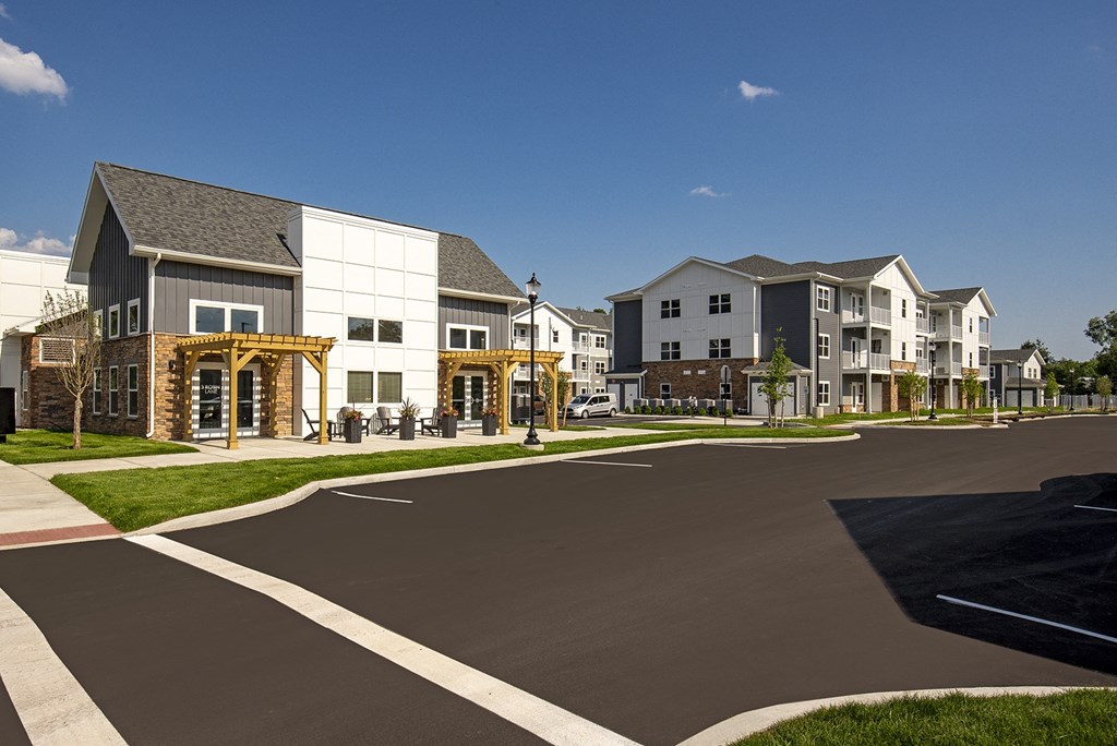 a view of an empty street with a row of apartment buildings