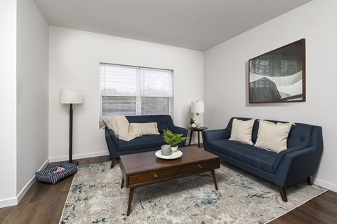 A living room with a blue couch and a coffee table.