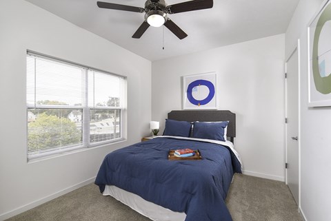 Spacious bedroom featuring a ceiling fan, modern finishes, and a bright, airy design for everyday comfort.