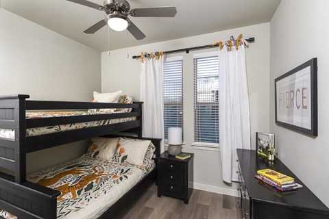 Bright secondary bedroom with comfortable furnishings, ample space, and a welcoming design suited for guests, family members, or a home office.