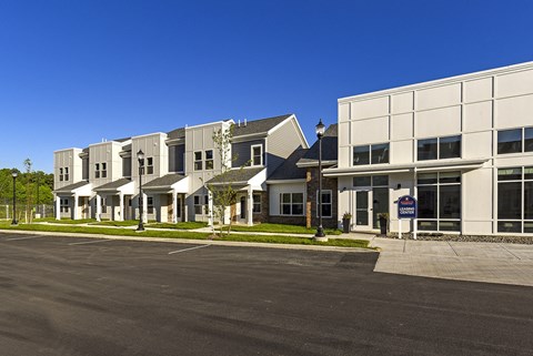a row of houses with a street in front of them