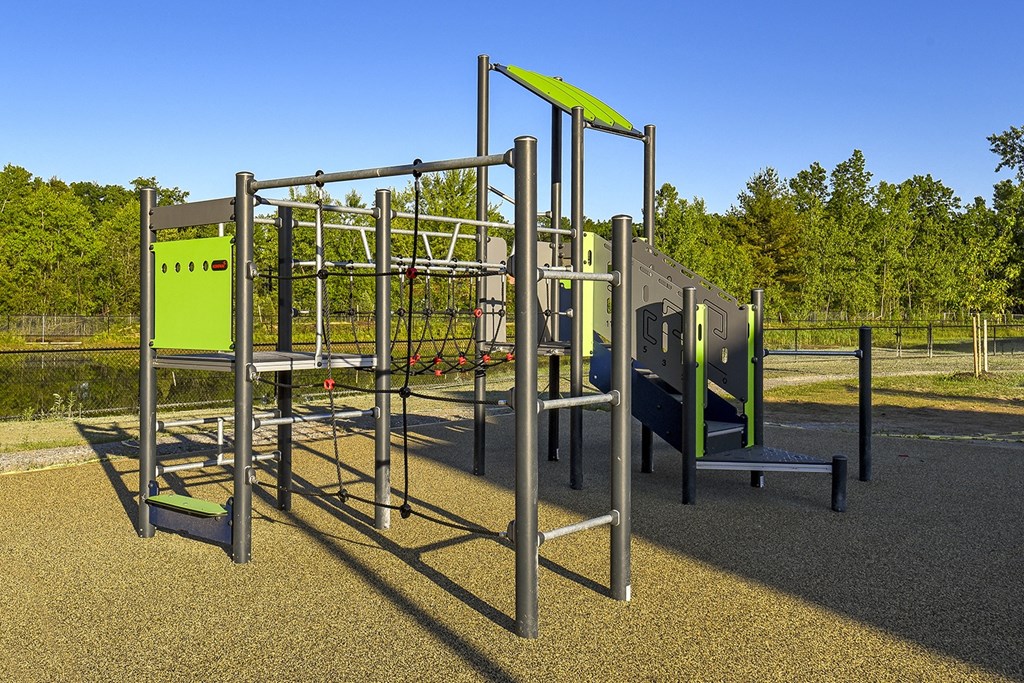 a playground with climbing equipment and benches