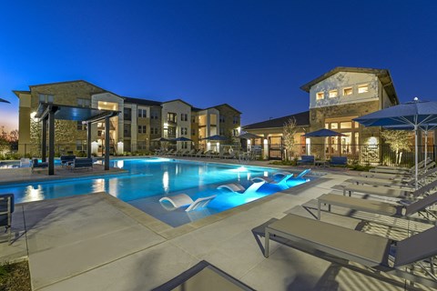 Resort-style swimming pool with comfortable lounge seating and a beautifully maintained outdoor space designed for relaxation.