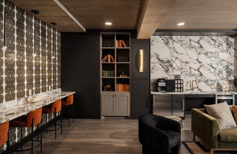 A modern kitchen with a bar area and a dining table.
