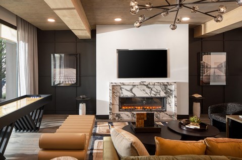 A modern living room with a fireplace and a television.