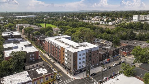 Aerial view of a modern apartment community featuring landscaped grounds, residential buildings, and thoughtfully designed outdoor spaces.