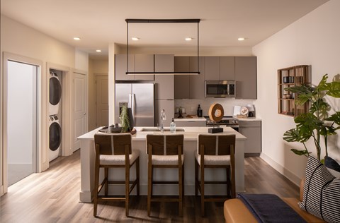 A modern kitchen with a dining table and chairs.