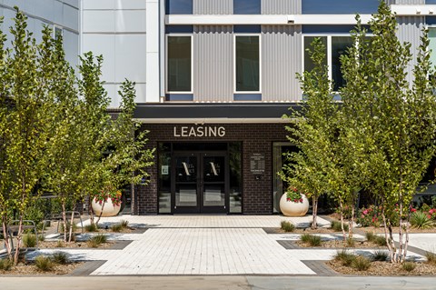 A building with a leasing sign in front of it.
