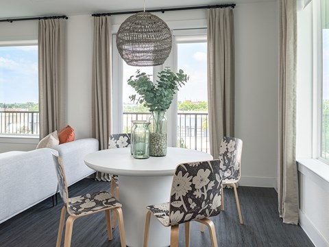a dining room with a table and chairs and a window