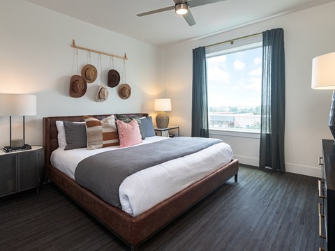 a bedroom with a large bed and a window
