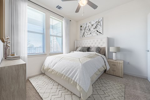 Spacious primary bedroom featuring comfortable furnishings, abundant natural light, and a relaxing atmosphere designed for everyday comfort.