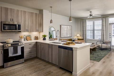 A modern kitchen with a large island and stainless steel appliances.