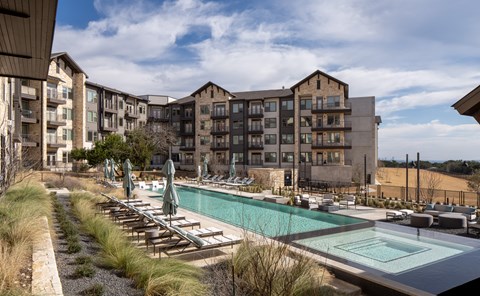 Resort-style swimming pool with comfortable lounge seating and a beautifully maintained outdoor space designed for relaxation.