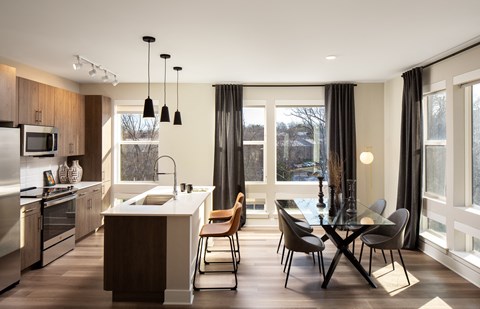 A modern kitchen with a dining table and chairs.