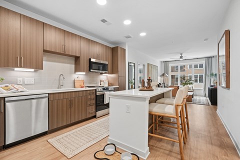 A modern kitchen with wooden cabinets and a white island.
