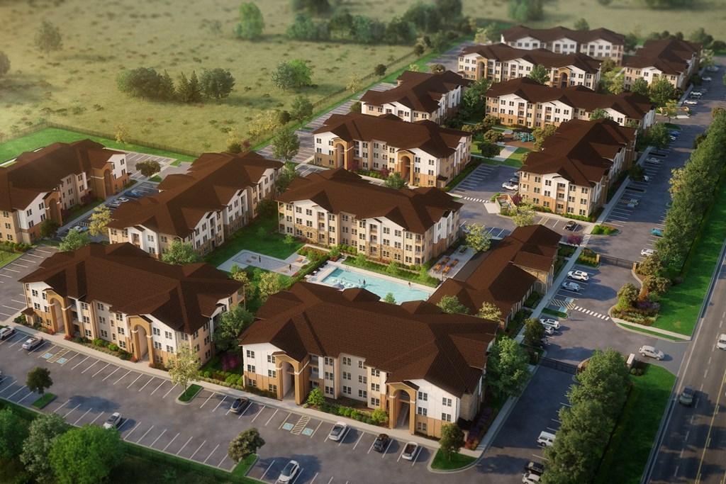 an aerial view of a subdivision with houses and cars on the street