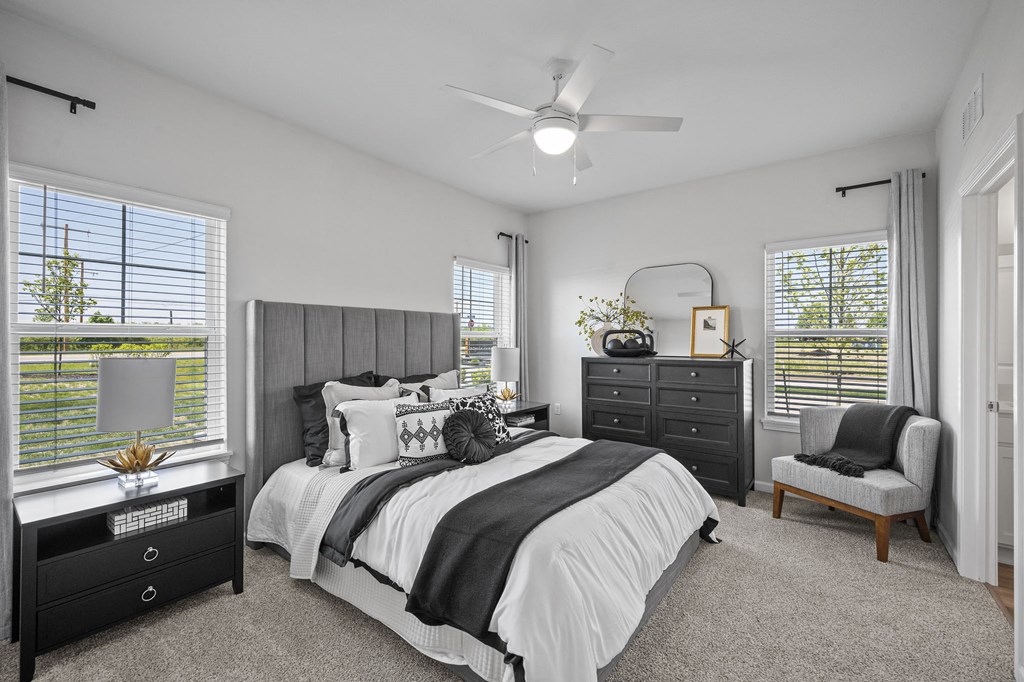 a bedroom with a bed and a ceiling fan