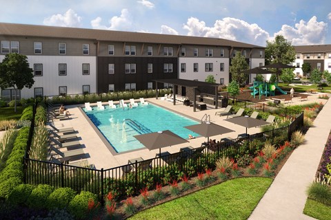 A pool surrounded by a black fence and a grassy area with trees.