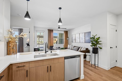 A modern kitchen with wooden cabinets and a white countertop.