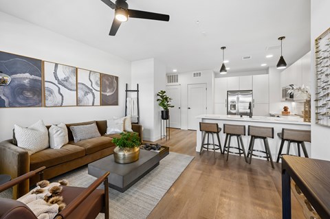 A modern living room with a brown sofa and a grey coffee table.