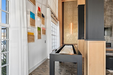 A modern kitchen with a table and a counter.