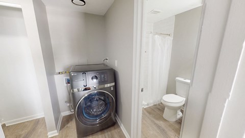 A small bathroom with a washer and dryer built in.