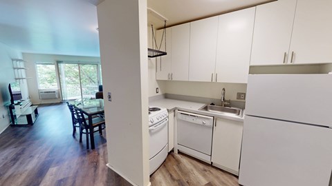 A kitchen with white appliances and cabinets.