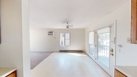 A spacious, empty room with a door and a window.