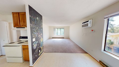 A kitchen with a white dishwasher and a fridge.