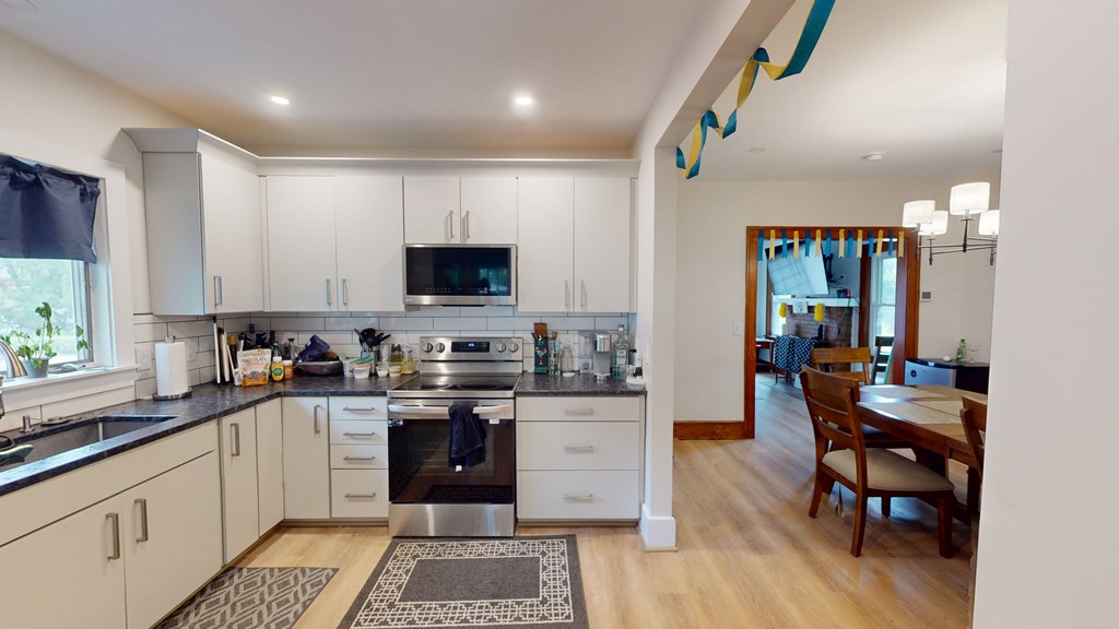 A modern kitchen with a large island and a dining area.