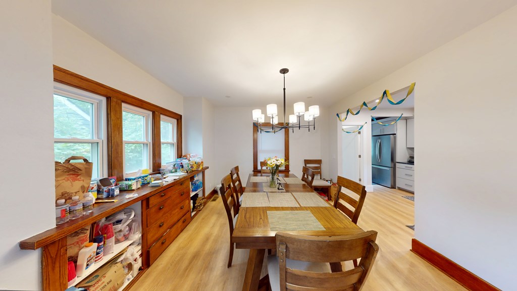 A dining room with a table set for six.