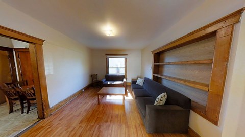 A living room with a couch and a chair.