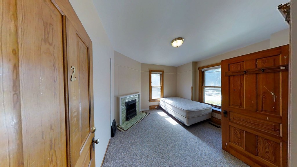 A room with a fireplace and a bed.