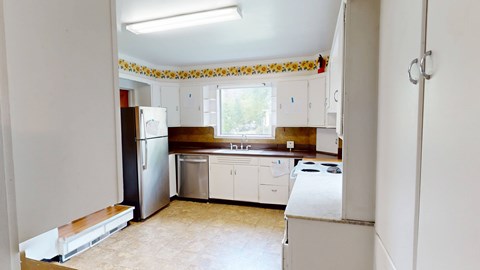 A kitchen with white appliances and cabinets.