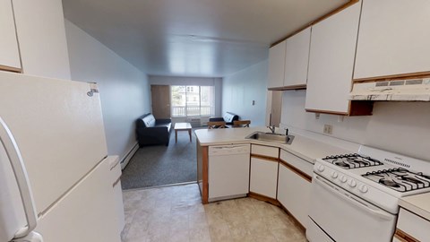 A kitchen with white appliances and cabinets.